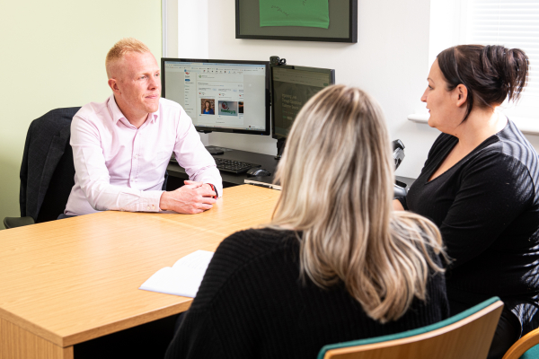 A group of the Dawleys team in conversation about data cleansing