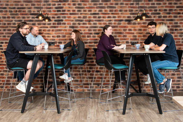 A group of Dawleys employees talking within their breakroom